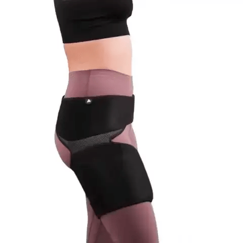 Black knee brace on a person's knee with a white background